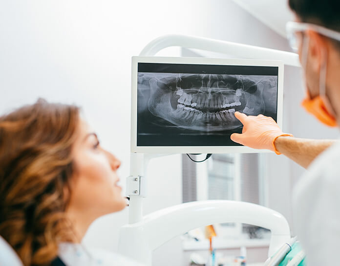 dentist telling a patient about her x-rays