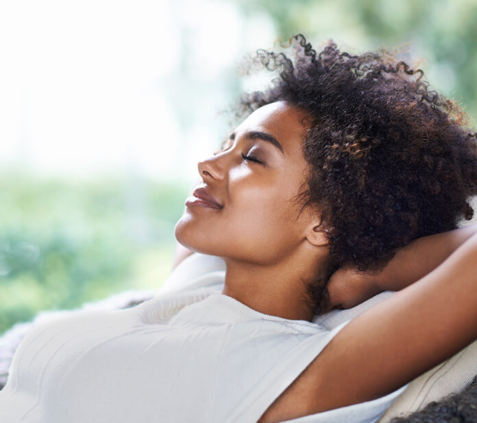 woman laid back and relaxing with her eyes closed