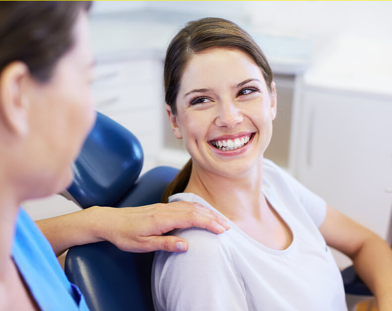 woman at the dentist with a bright, beautiful smile