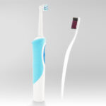 Photo of an electric toothbrush facing off with a manual toothbrush.