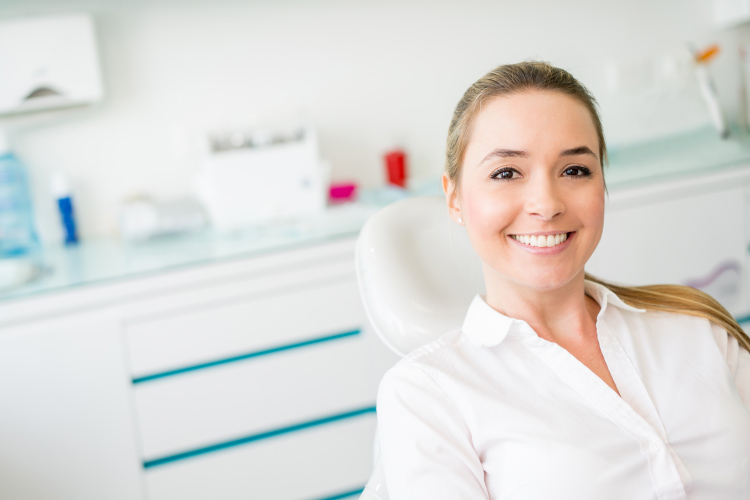 Smiling woman in the dental chair for a botox treatment.