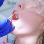 Patient getting a fluoride treatment in the dental chair.